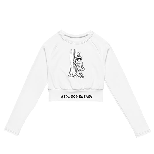 White long-sleeve crop top with graphic design and text on a white background