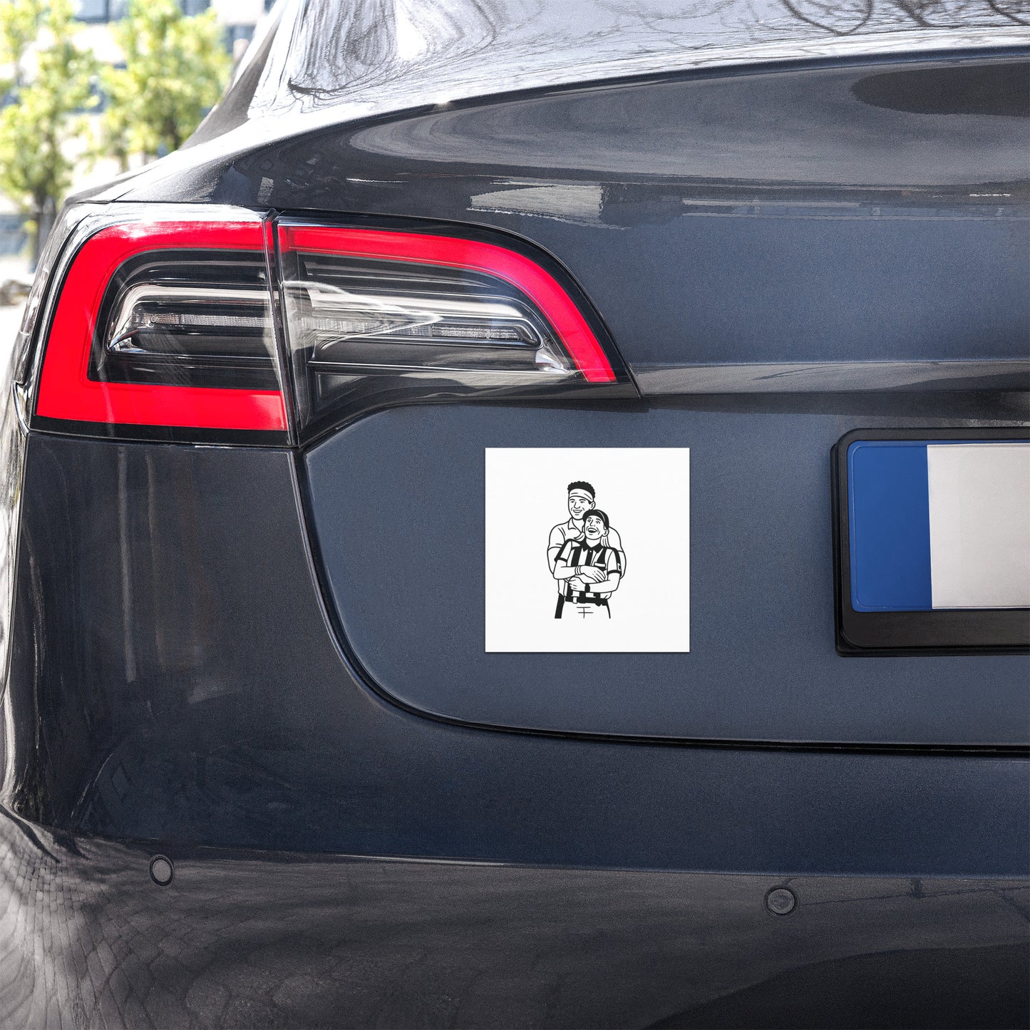 Car with a sticker of a person holding a child on the back