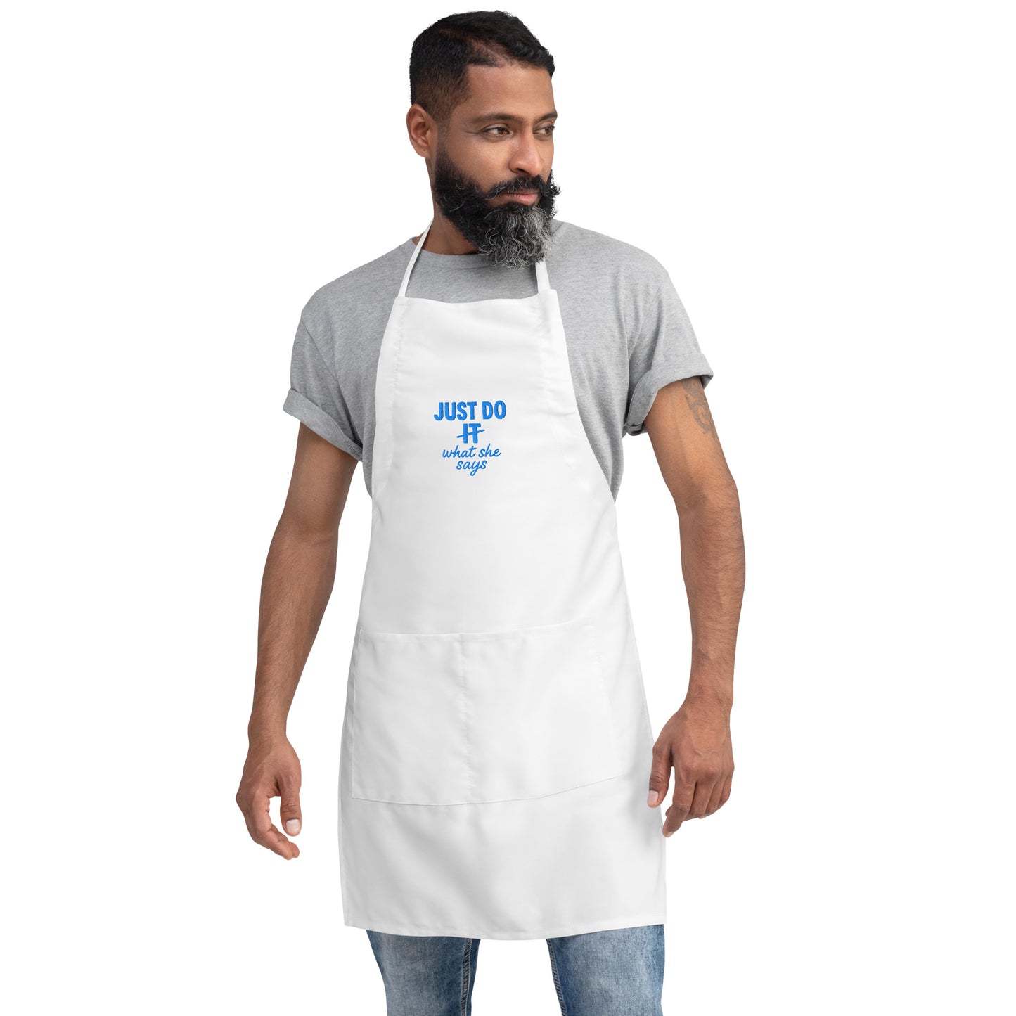 Man wearing a white apron with blue text on a white background