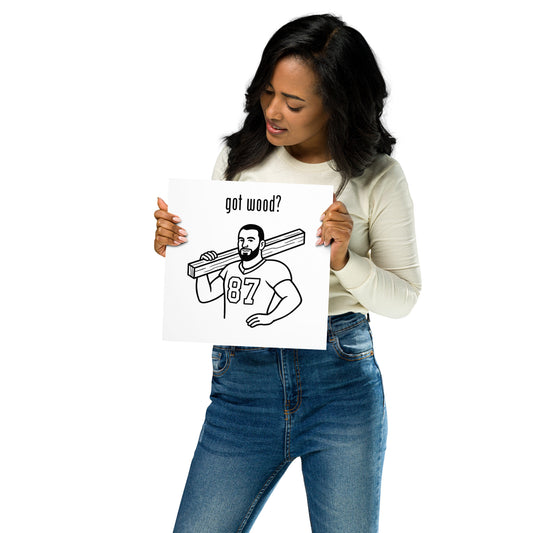 Woman holding a sign with a graphic and text 'got wood?' on a white background