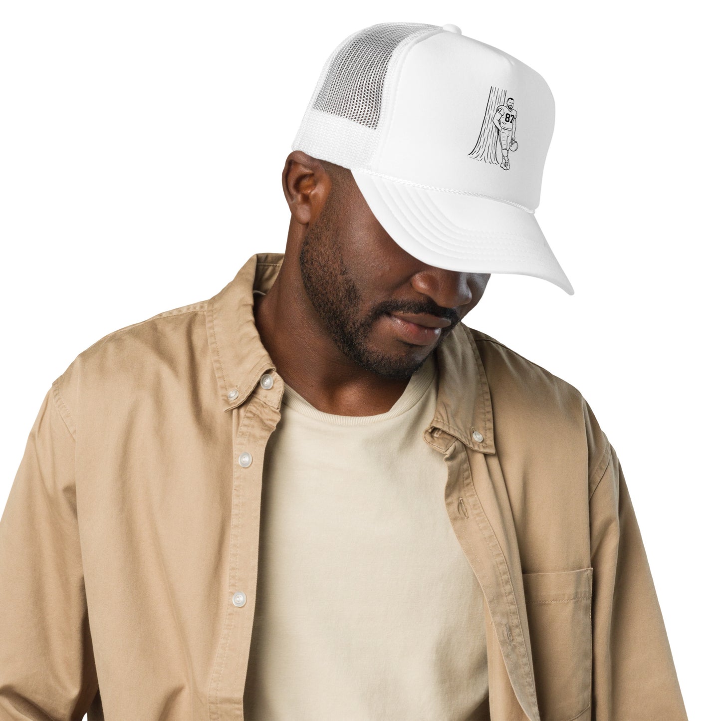 Man wearing a white cap and beige jacket on a white background