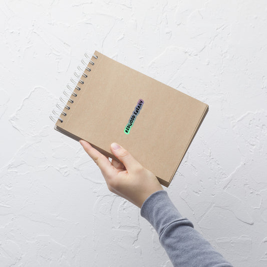 Hand holding a brown notebook with a textured white background