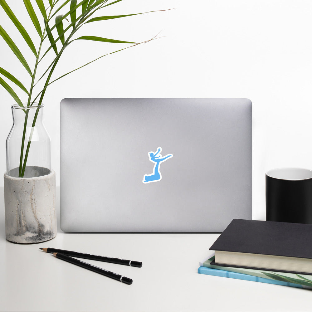Air Jordon Logo of a man holding a woman in blue stuck to a laptop with a pen, glasses, mouse, notepad, and two small desk plants surrrounding the laptop.