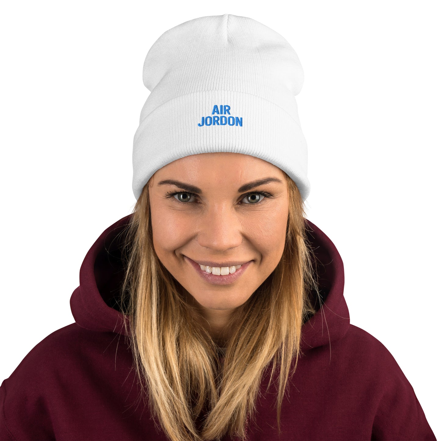 Person wearing a white beanie with 'AIR JORDAN' text and a maroon hoodie on a white background