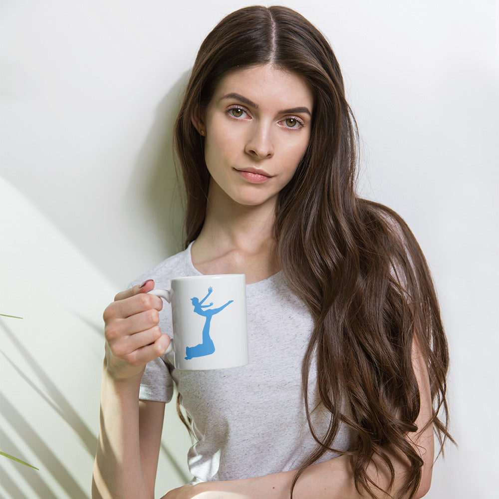 Woman holding a mug with a blue design on a white background