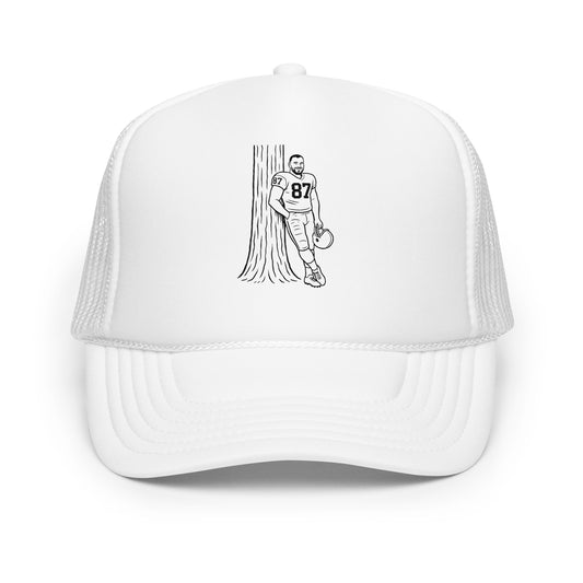 White cap with a black and white illustration of a football player and tree on a white background
