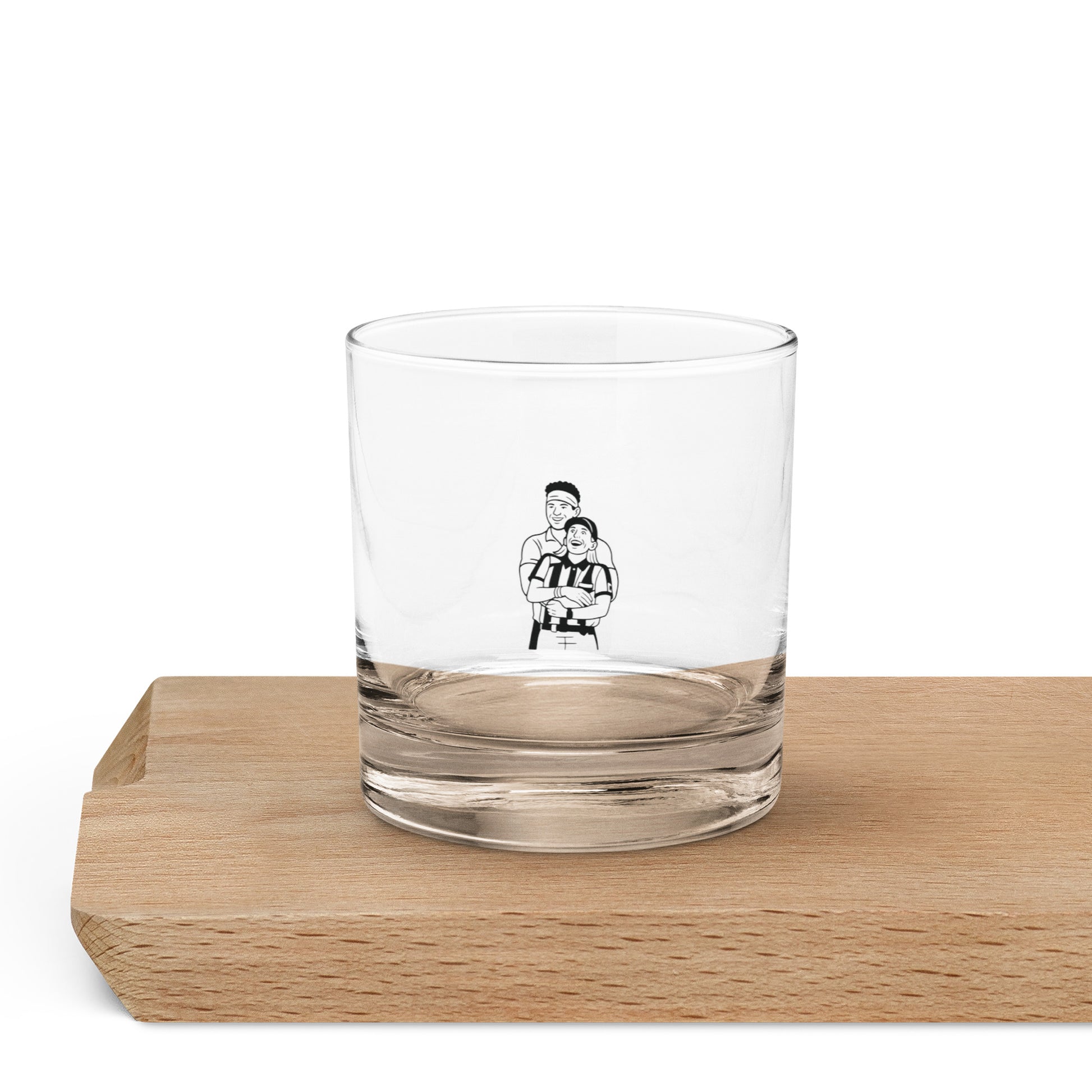 Clear glass with a black and white illustration on a wooden coaster
